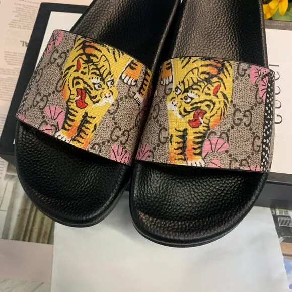Authentic Gucci rubber slides with tiger detailing