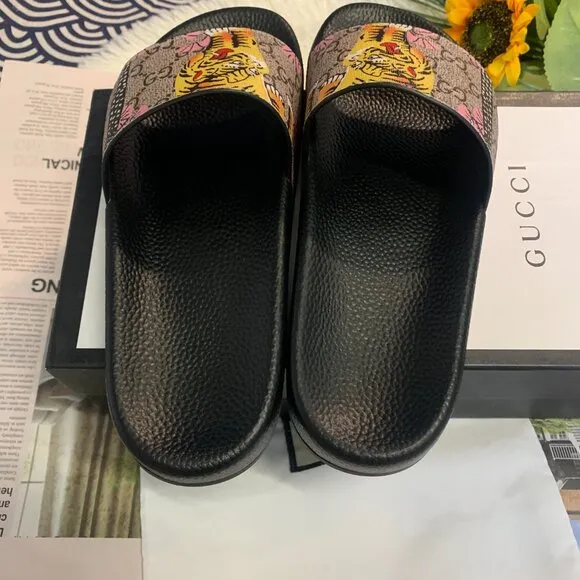 Authentic Gucci rubber slides with tiger detailing