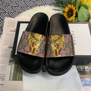 Authentic Gucci rubber slides with tiger detailing