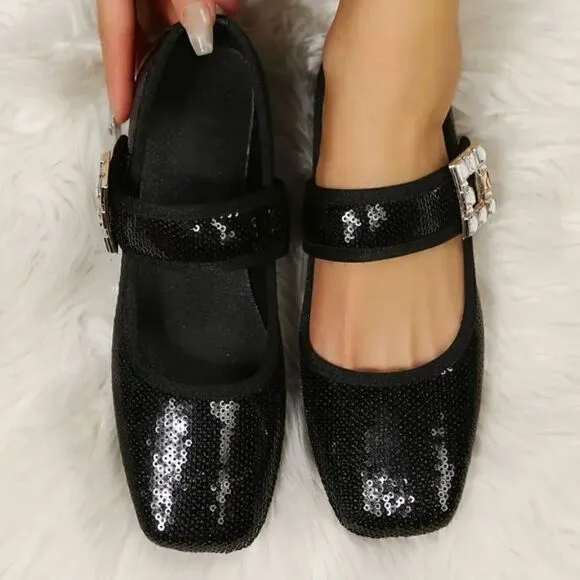 Black sequin flats with crystal and metal strap embellishments.