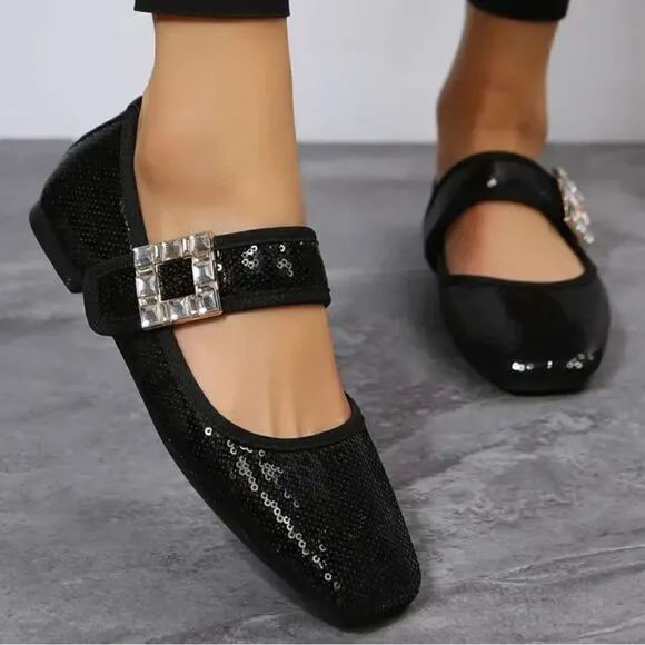 Black sequin flats with crystal and metal strap embellishments.